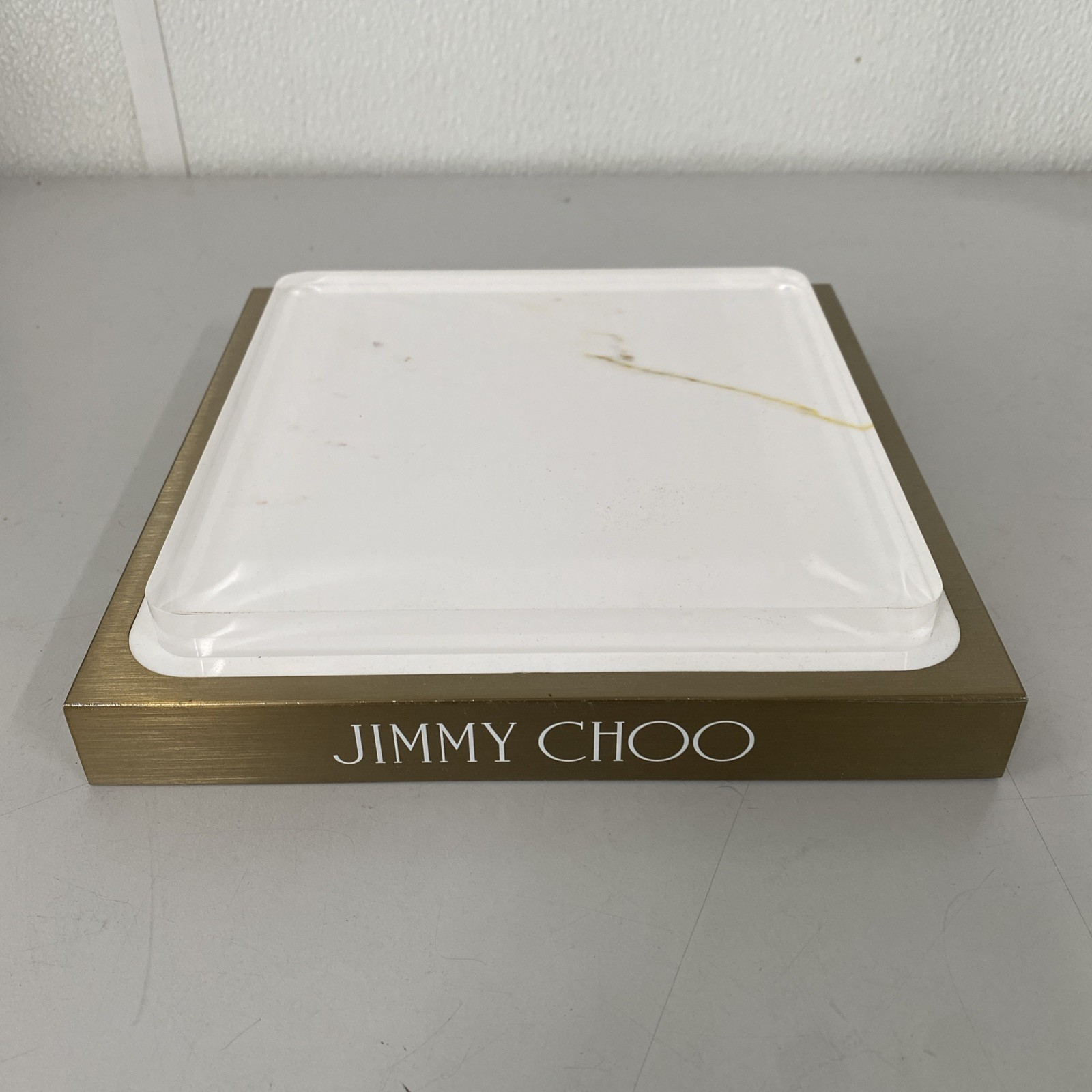 JIMMY CHOO GOLD & WHITE ONE PIECE LOGO DISPLAY IN STEEL METAL BRONZE PLEXIGLASS