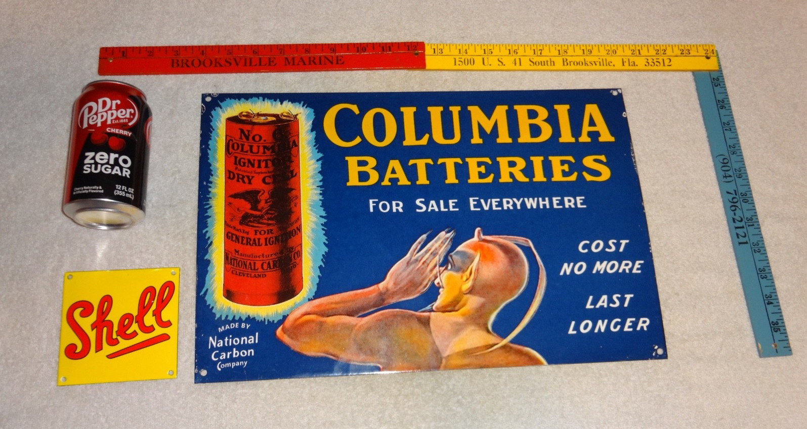 VINTAGE COLUMBIA DRY CELL BATTERIES +DEVIL 16″ PORCELAIN METAL GASOLINE OIL SIGN