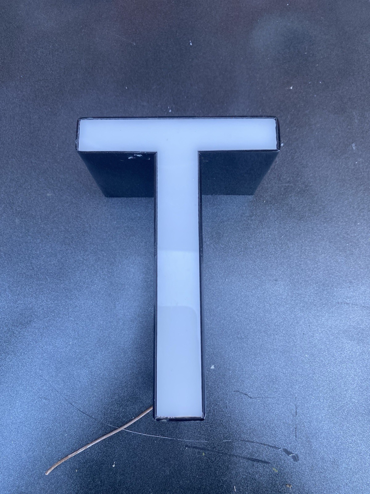 Letter t Ex Sign White Front Black Edge Plex