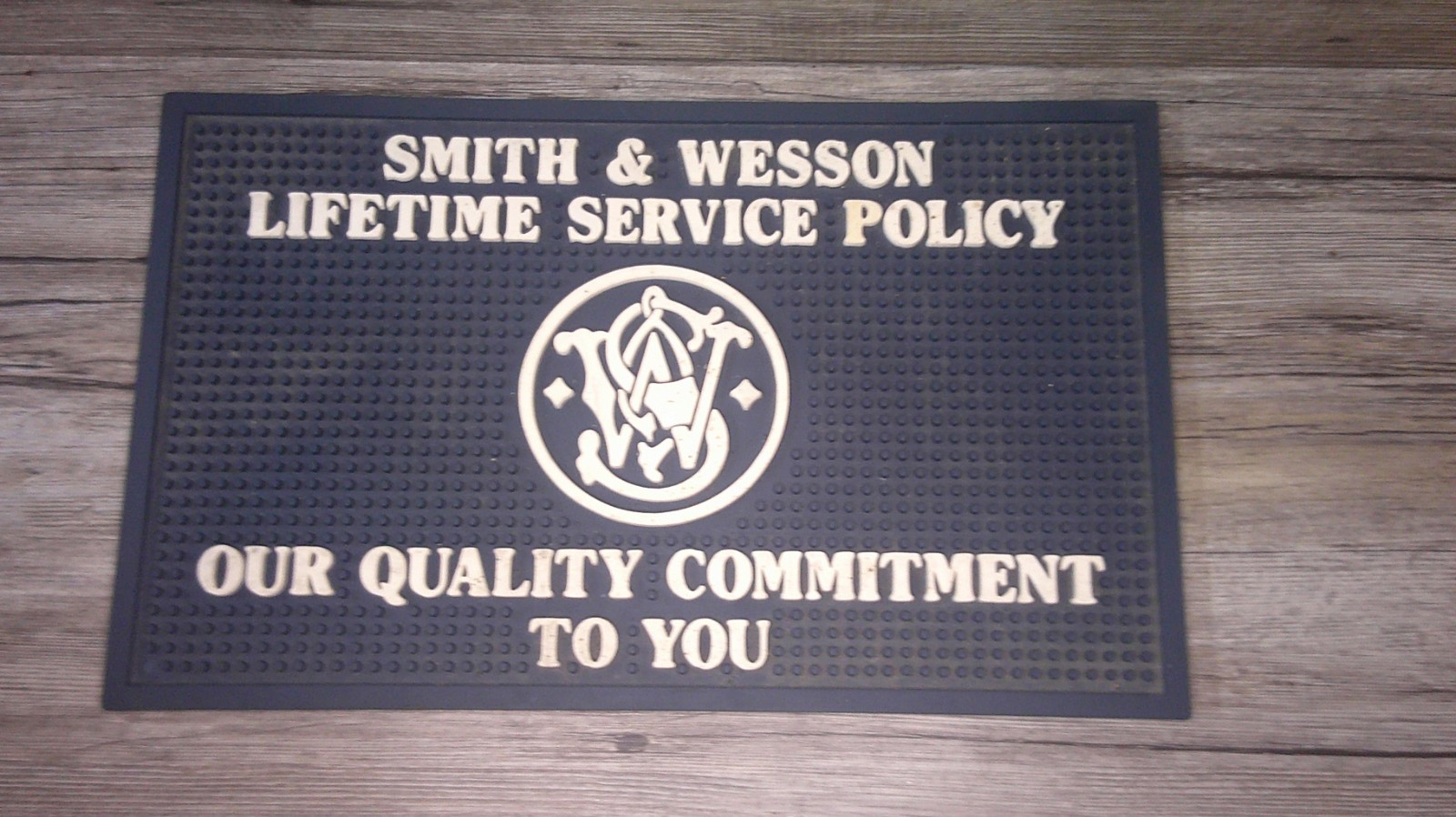 vintage Smith And Wesson store counter advertising rubber mat lifetime service