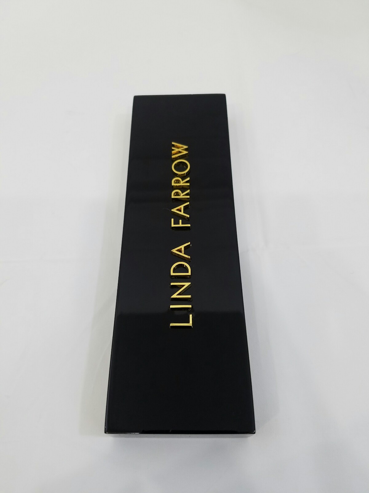 LINDA FARROW LOGO SHINY BLACK PLAQUE WITH GOLD LETTERING W/ REVO ADVERT PLAGUE