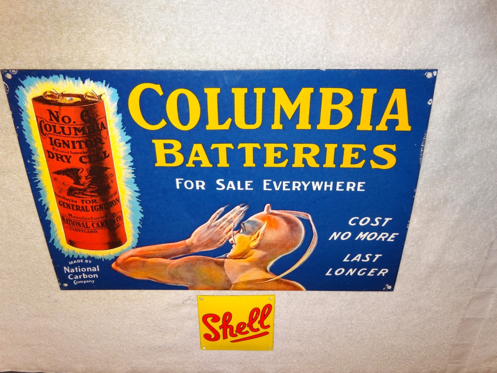 VINTAGE COLUMBIA DRY CELL BATTERIES +DEVIL 16″ PORCELAIN METAL GASOLINE OIL SIGN