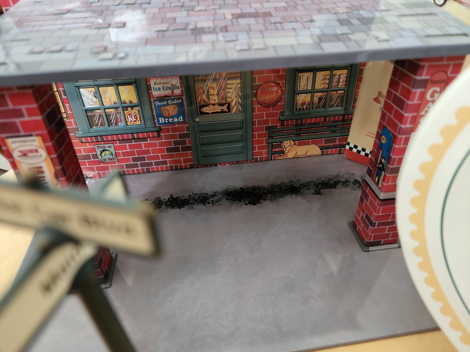 Hallmark Kiddie Car Classics in store display and used garage with street signs.