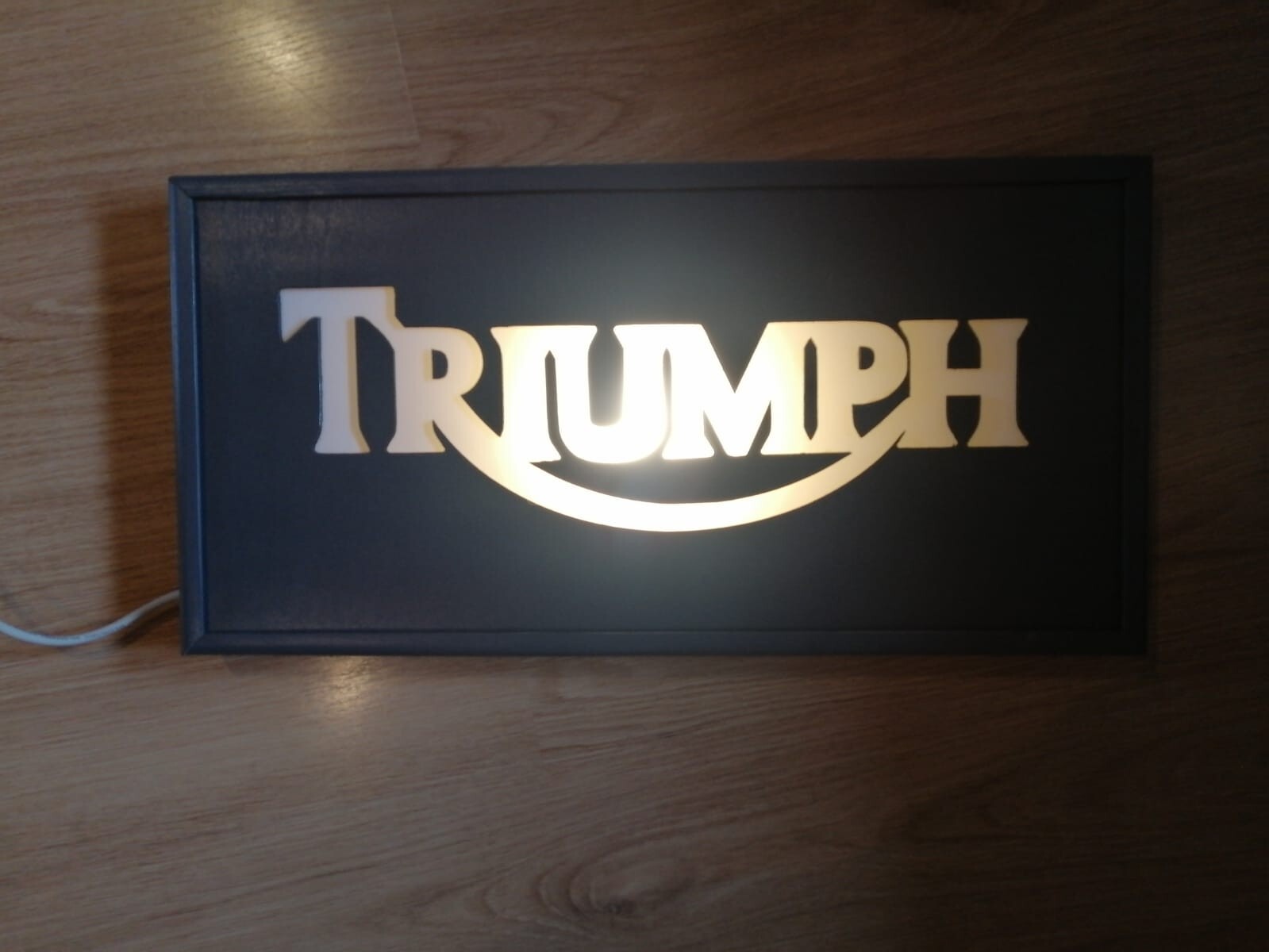 Triumph sign, light plate, table