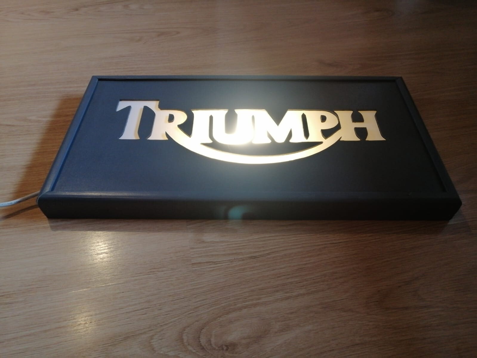 Triumph sign, light plate, table