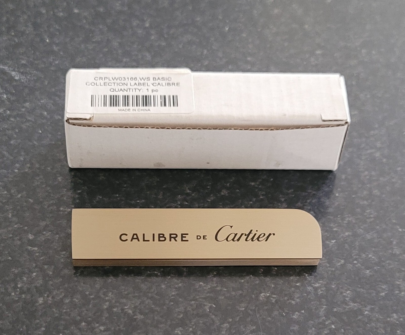 ORIGINAL CARTIER “CALIBRE DE CARTIER” DEALER’S BRASS PLAQUE BRAND NEW