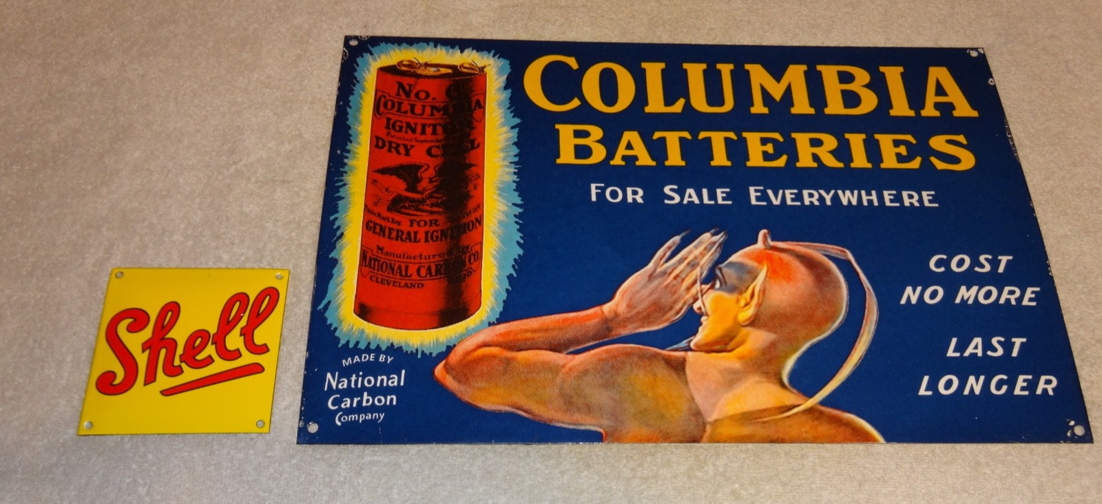 VINTAGE COLUMBIA DRY CELL BATTERIES +DEVIL 16″ PORCELAIN METAL GASOLINE OIL SIGN
