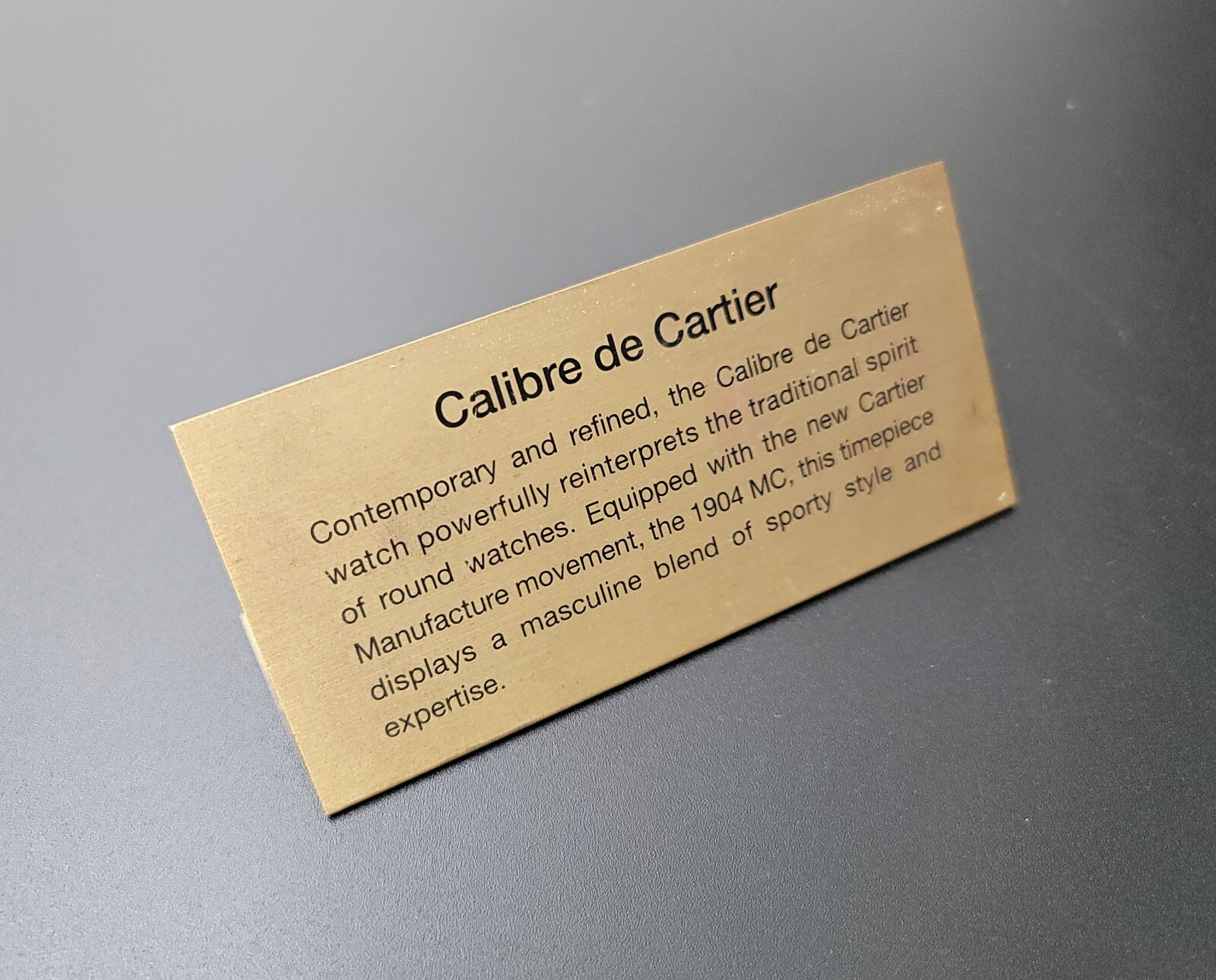GENUINE CARTIER “CALIBRE DE CARTIER” DEALER’S PRESENTATION BRASS PLAQUE