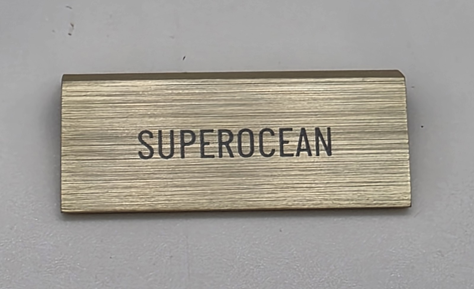 ORIGINAL OMEGA “SUPEROCEAN” SMALL DEALER’S BRASS PLAQUE PRE-OWNED