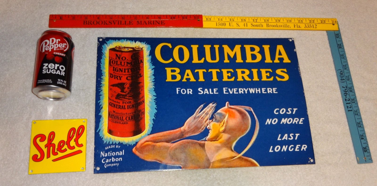 VINTAGE COLUMBIA DRY CELL BATTERIES +DEVIL 16″ PORCELAIN METAL GASOLINE OIL SIGN